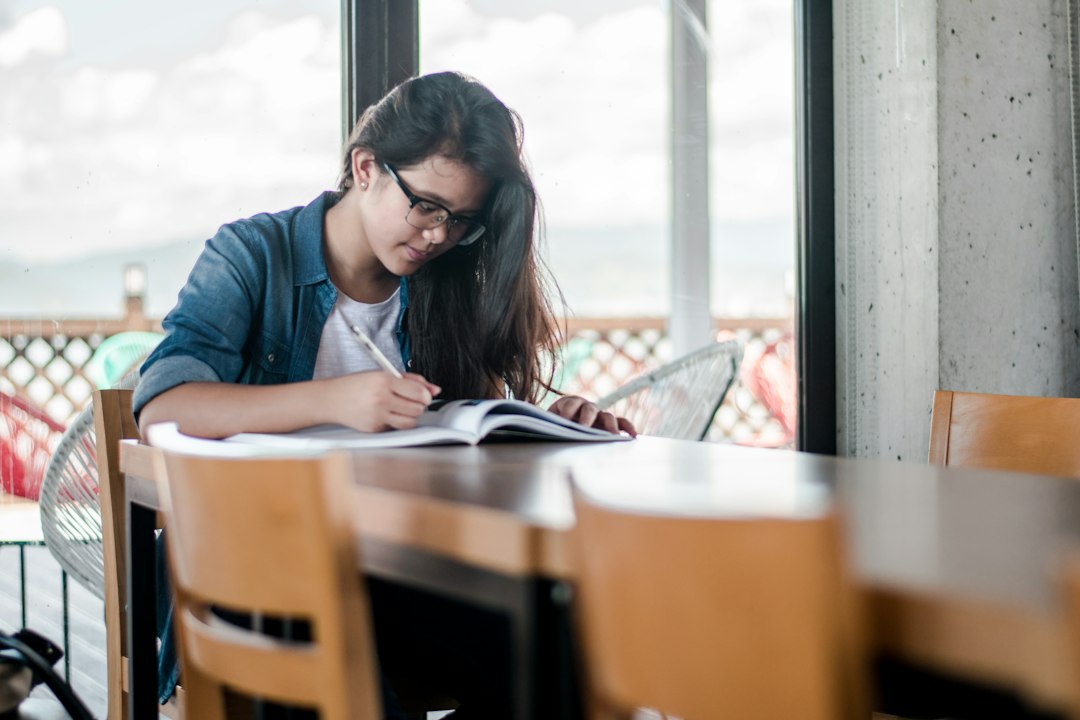Student writing study notes as part of OET preparation for nurses